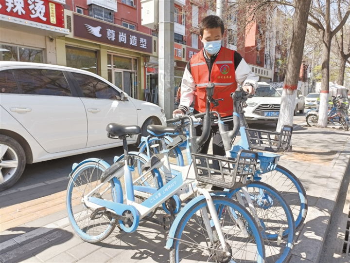 百余“红马甲”齐动手，共享单车“各就各位”